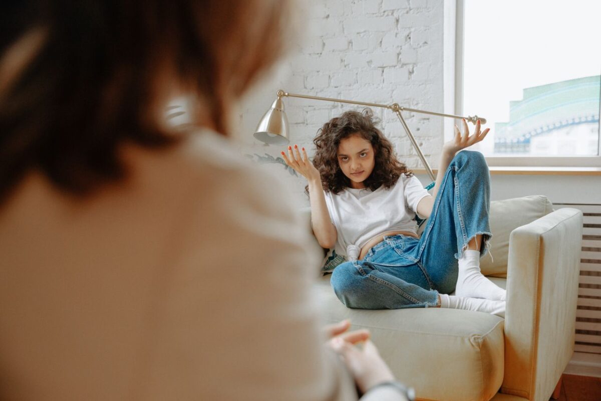 A young woman expressing frustration during a counseling session.